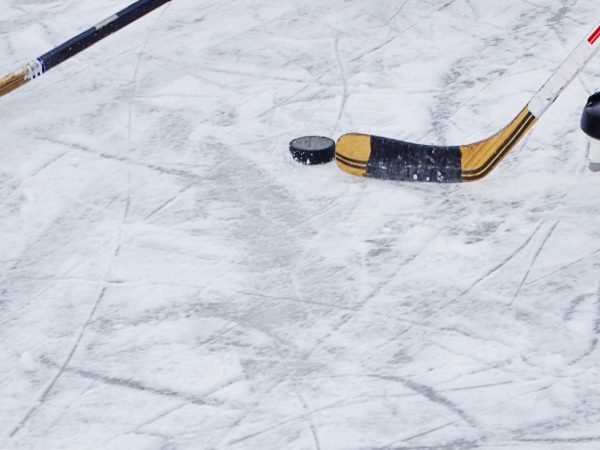 Picture of a hockey player navigating a puck on ice.